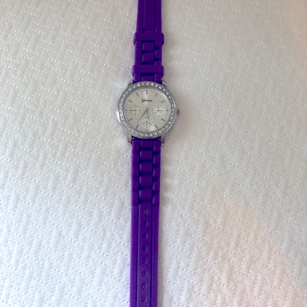 Purple watch with faux diamonds around the face.
